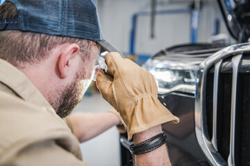 Wall Mural - Mechanic Checking Car Headlights