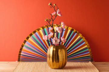 Wall Mural - Chinese New Year decorations on wooden table over red background