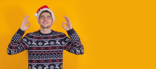 Poster - isolated young man with santa claus hat celebrating christmas