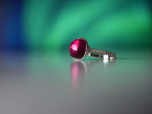 Red Crystal Ring On Blue Green Background
