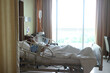 © sittinan - Giving saline to the hand of a patient medical treatment. Patient on hospital bed for background usage.