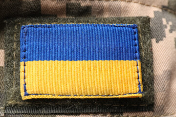Wall Mural - Ukrainian army patch on military camouflage, closeup