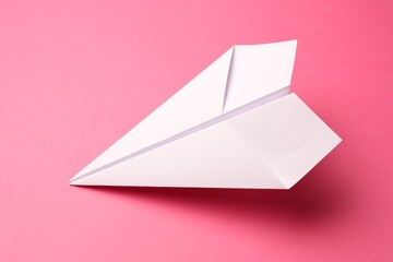 Canvas Print - Handmade white paper plane on pink background