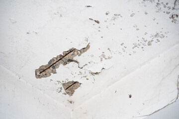 Wall Mural - Water damaged ceiling roof in an old house. Water damage building interior. Ceiling house broken. Ceiling concrete crack and exposed the rusty steel bar frame.