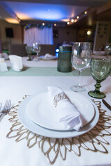 Wall Mural - 
Serving and decoration of the wedding table. Glasses, spoons, forks and white napkins