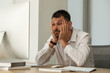 © New Africa - Sleep deprived man at workplace in office