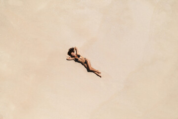 Wall Mural - Top Aerial Drone View of Woman in Swimsuit Bikini Relaxing and