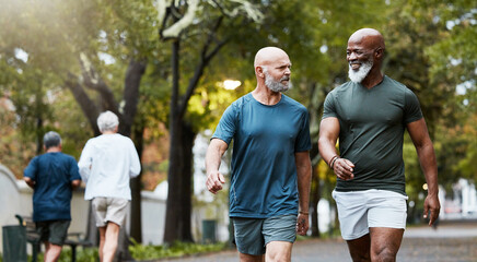 fitness, exercise and men walking together at community park while talking and doing cardio training