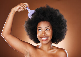 Wall Mural - Beauty, hair care and black woman with afro comb in studio isolated on a brown background. Afro, wellness and happy female model with hair tool for hairstyle, salon treatment or healthy hair.