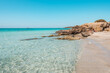 Elafonisi, crete island, greece: pink colored sandy beach with black rocks at the famous cretan lagoon
