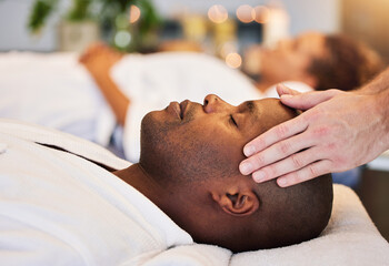 Canvas Print - Black man, relax and head massage with therapist hands in a luxury spa, wellness and skincare on a bed. Masseur with relax client in zen, calm or peace luxury hotel salon for physical body therapy