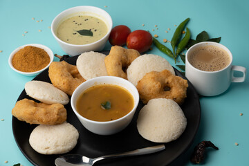 Wall Mural - south indian food called idli vada sambar or sambar vada or wada, served with coconut chutney and south indian style hot coffee