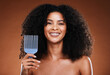 Black woman, hair care and smile in portrait with comb, afro pick or beauty against brown backdrop. Happy African, model and woman with cosmetics, makeup or happiness for combing by studio background