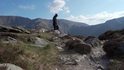 Wall Mural - An adventurer walking along a beautiful mountain ridge in North Wales