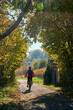 © Uwe - nice senior woman riding her electric mountain bike in the steep autumnal colored vineyards of River Neckar Valley,Baden-Wuerttemberg, Germany