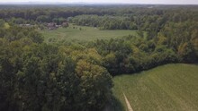 Aerial Drone Footage Of A Rural Area With Agricultural Lands And Lush Green Vegetation In Sunlight