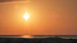 © Bernard - La beauté de la nature avec ce vol de flamants roses en photo minimaliste dans un ciel orange au coucher de soleil au dessus de la mer en Camargue