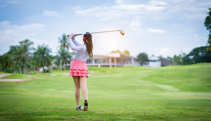 Wall Mural - Professional woman golfer teeing golf in golf tournament competition at golf course for winner.	