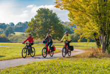 Three Happy Senior Adults, Riding Their Mountain Bikes In The Autumnal Atmosphere Of The Fall Forests Around City Of Stuttgart, Baden Wuerttemberg, Germany

