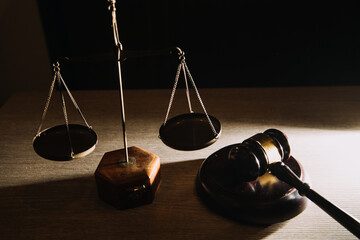 Business and lawyers discussing contract papers with brass scale on desk in office. Law, legal services, advice, justice and law concept picture with film grain effect