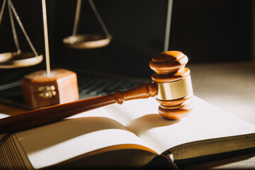 Business and lawyers discussing contract papers with brass scale on desk in office. Law, legal services, advice, justice and law concept picture with film grain effect