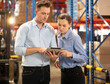© Nassorn - Distribution warehouse manager and client businesswoman using digital tablet checking inventory storage on shelf. Storehouse supervisor worker and logistic engineer standing together at storage room.