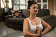 Beautiful pregnant woman practising yoga at home. Woman doing stretching exercise..