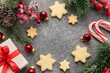 © Olena Rudo - Christmas background with gingerbread cookies, gift boxe and fir branches  on darck concrete background.