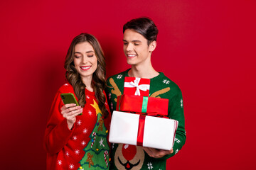 Poster - Photo of two funny cheerful people use telephone hold pile stack box package giftbox isolated on red color background