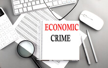 ECONOMIC CRIME Text On Notepad On Chart With Keyboard And Calculator On Grey Background