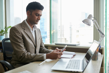 Wall Mural - businessman answering text messages