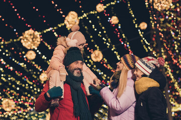 Poster - Portrait of attractive cheerful family having fun visiting festal eve fair shopping sale strolling traveling city urban outdoors