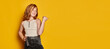 Flyer. Portrait of little stylish girl with long red hair and freckles isolated over bright yellow background. Concept of children emotions, dance, music, happiness