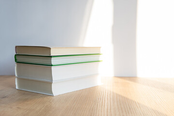 Wall Mural - books on a wooden table. a stack of books on a white background.