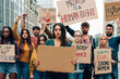 © Carlo - group of young activists holding panels protesting for equality gender and climate change - girl holding banner with copy space