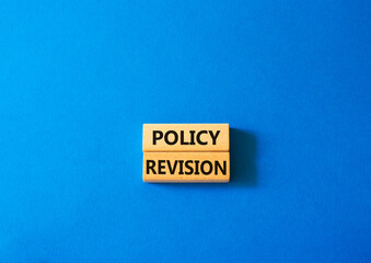 Sticker - Policy revision symbol. Concept word Policy revision on wooden blocks. Beautiful blue background. Business and Policy revision concept. Copy space