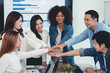© amnaj - Young Asian business people shaking hands and working together as a team and having unity in working on new start-up project. Unity and Teamwork Concept.