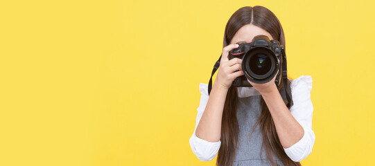 Sticker - happy teen girl photographer taking picture with digital photo camera, copy space, photographing. Child photographer with camera, horizontal poster, banner with copy space.