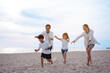 © Kiattisak - Happy asian family enjoy the sea beach at consisting father, mother,son and daughter having fun playing beach in summer vacation on the ocean beach. Happy family with vacations time lifestyle concept.