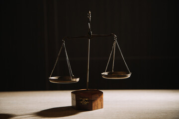 Justice and law concept.Male judge in a courtroom with the gavel, working with, computer and docking keyboard, eyeglasses, on table in morning light