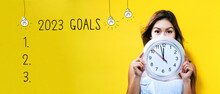 2023 Goals With Young Woman Holding A Clock Showing Nearly 12
