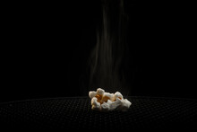 Hot Popcorn On A Black Background.
Popcorn With Smoke Close-up.