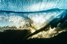 Underwater Point Of View Of Surfer On Wave