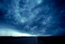 Storm Clouds Loom Above A Highway, Canada, North America.