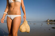 © Cavan Images - cute young brunette girl enjoys a day at the beach with surf board