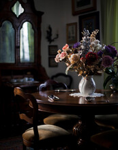 A Bouquet Of Flowers In A Vase On A Brown Table.