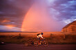 © Cavan Images - Mountain biking past a rainbow near Driggs, Idaho.
