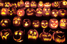 Rows Of Pumpkins Are Carved And Illuminated With Candles In Celebration Of Halloween.