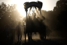 A Statue Of Saint Isidore The Farmer, Is Carried In A Carriage Along A Dusty Road During A Pilgrimage In Prado Del Rey Village, Cadiz Province, Andalusia, Spain, May 16, 2010.