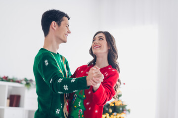 Canvas Print - Portrait photo of two young students wear ugly sweaters hands together enjoy christmas spirit dancing music rhythm chilling near fir tree indoors